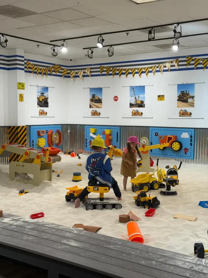Children playing in the clean indoor sand arena at DigLand Kids