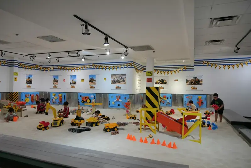 The sand arena with ride-on diggers, cones and activity panels