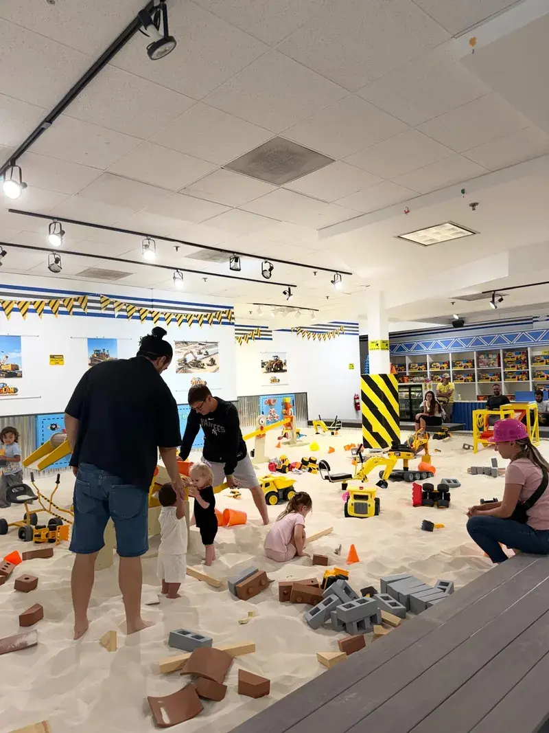 Families spread across the sand arena on a busy day