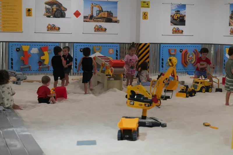 Several children playing across the sand