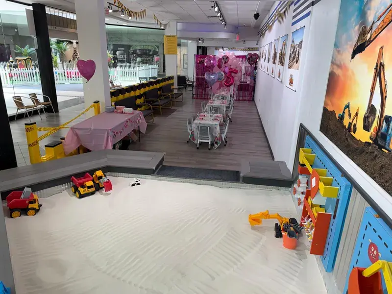 The party area set up with tables, balloons and seating